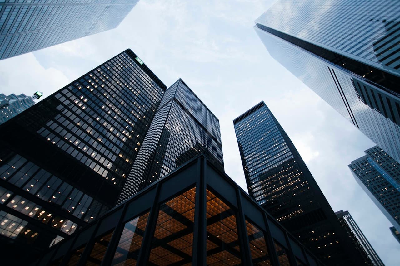Corporate towers viewed from below against the sky